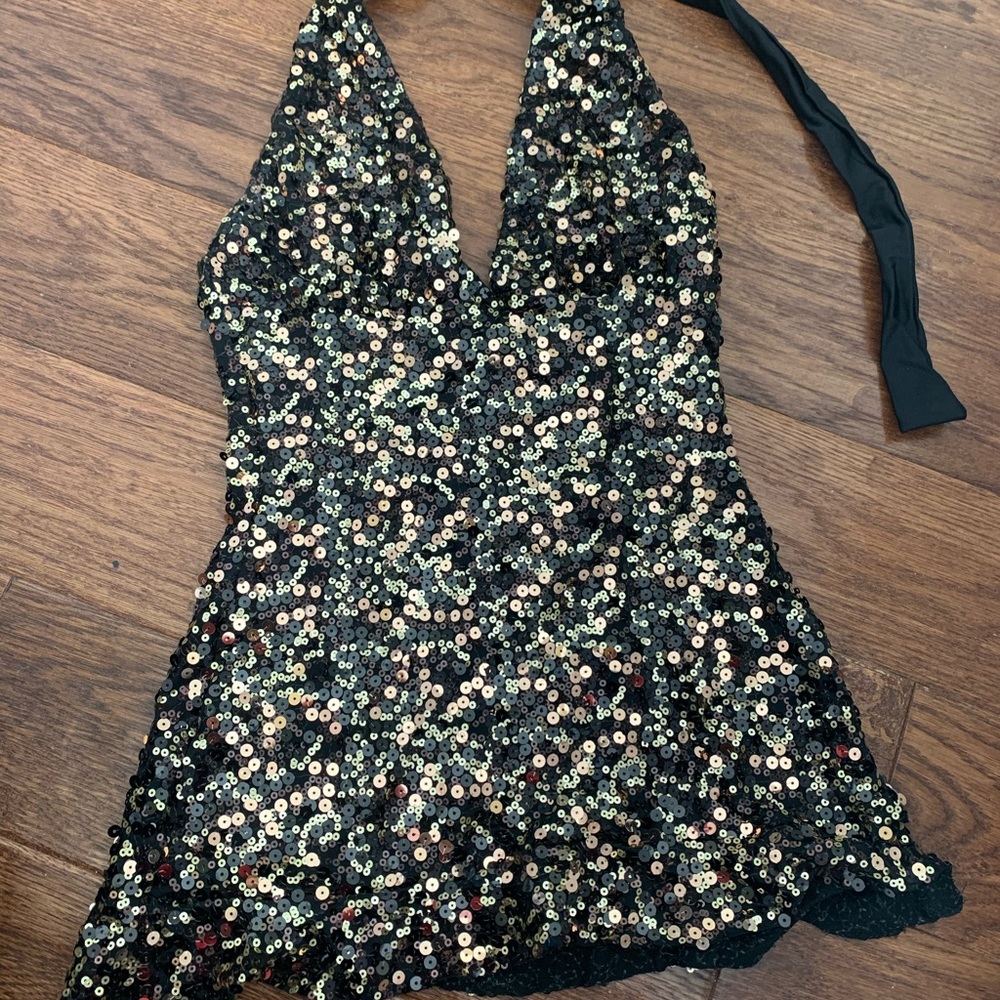 Sequined black and gold halter dress.